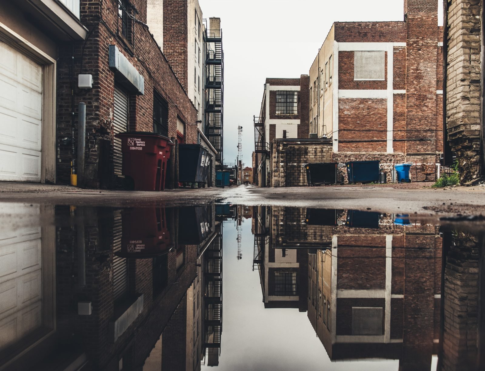 Picture of urban scene reflected in a still puddle.